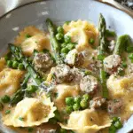 Creamy Asparagus Ravioli with Sausage and Peas
